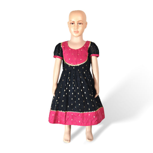 A mannequin showcasing a black and pink Chanderi cotton frock with dotted and star patterns.