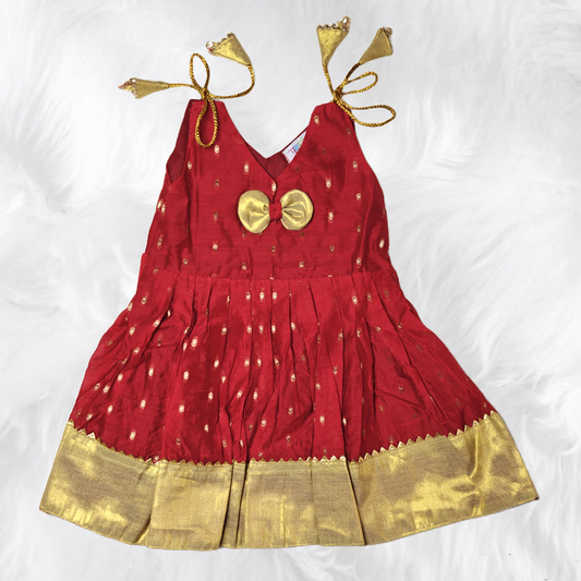 Toddler girl's red and gold shoulder knot frock with dotted pattern and rhinestone embellishments.