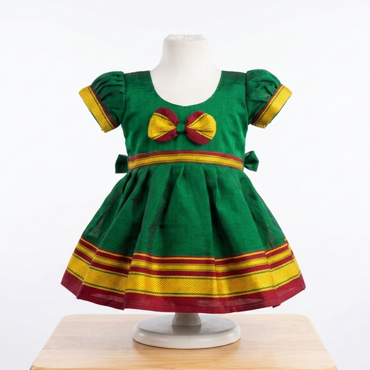Green Irkal frock displayed on baby mannequin for newborn naming ceremony collection