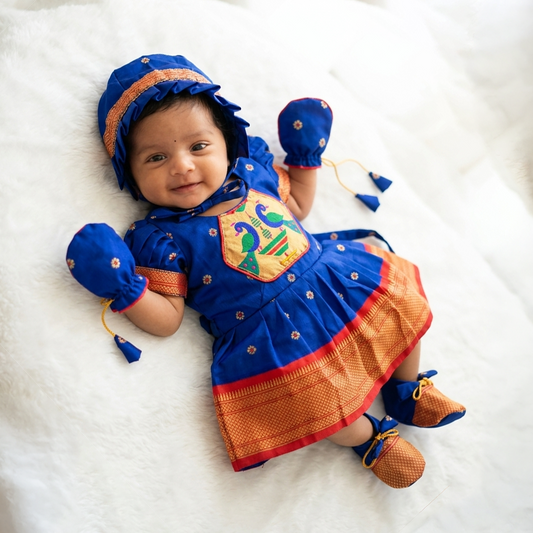 Newborn baby girl photoshoot in royal blue Paithani frock set with bonnet mittens and booties
