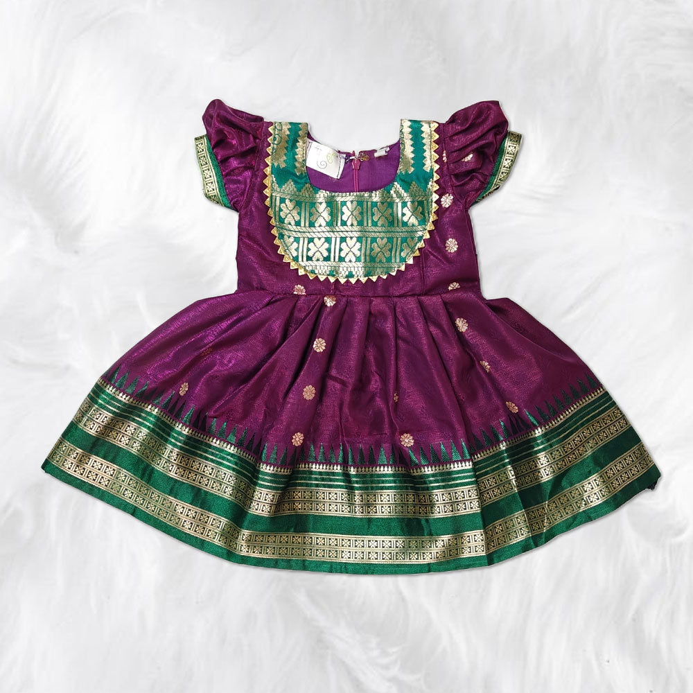 Elegant traditional frock for kids with gold zari border, perfect for festive occasions.