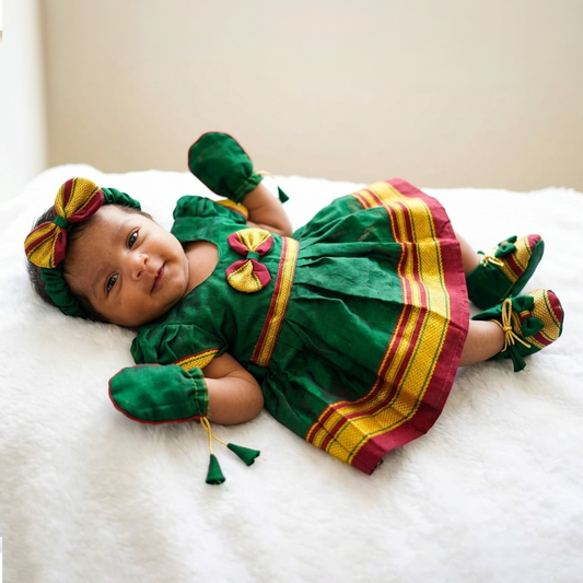 Baby girl wearing green Irkal festive outfit for naming ceremony and baby welcome function