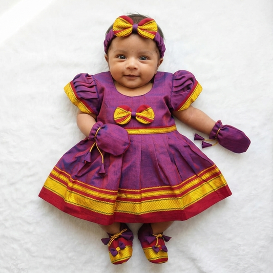 Newborn baby girl in purple Paithani frock set with mittens shoes and headband