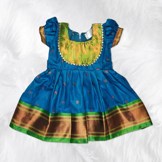 Traditional Indian frock for kids featuring rich fabric and detailed handwork.