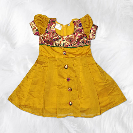 Newborn baby girl in pastel traditional frock design, soft and comfortable fit.