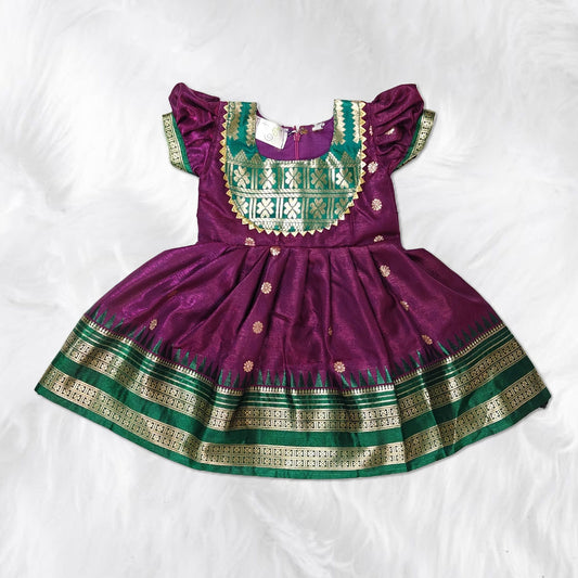 Elegant traditional frock for kids with gold zari border, perfect for festive occasions.